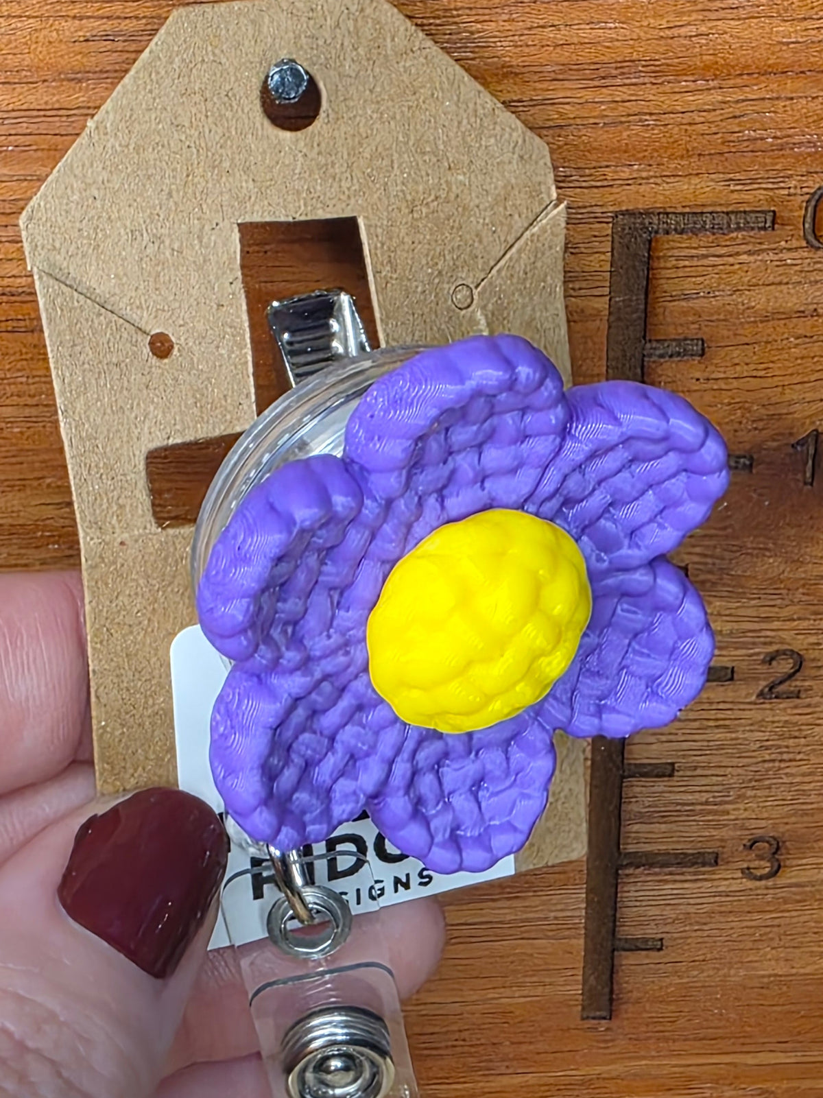 Purple daisy badge reel